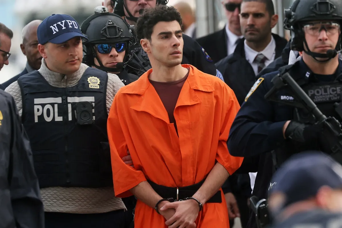 Luigi Mangione, suspect in the killing of UnitedHealthcare CEO Brian Thompson in New York City, arrives at a heliport with members of the NYPD on December 19, 2024 in New York City.