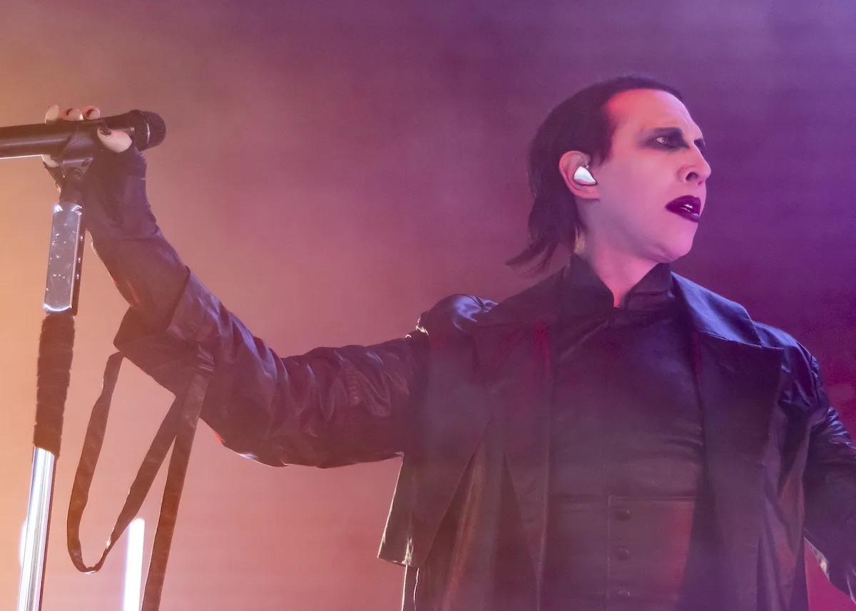 Marilyn Manson, dressed in black, performs in 2024