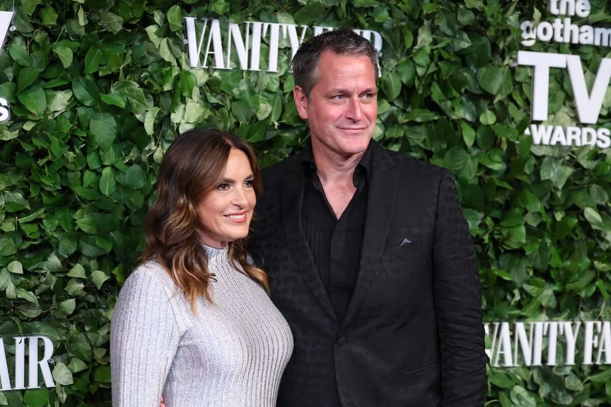 Mariska Hargitay and Peter Hermann posing at the 2024 Gotham TV Awards in a silver dress and black suit respectively.