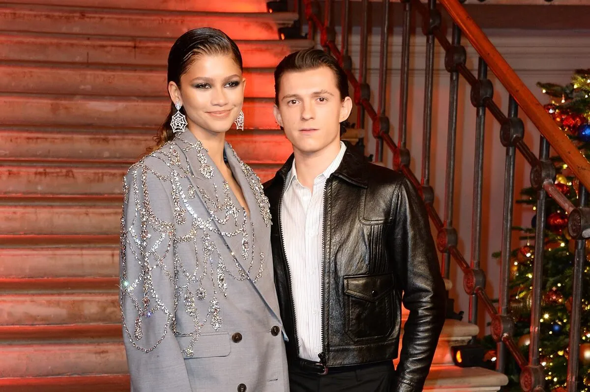 Zendaya and Tom Holland posing alongside each other at a photocall for "Spider-Man: No Way Home".