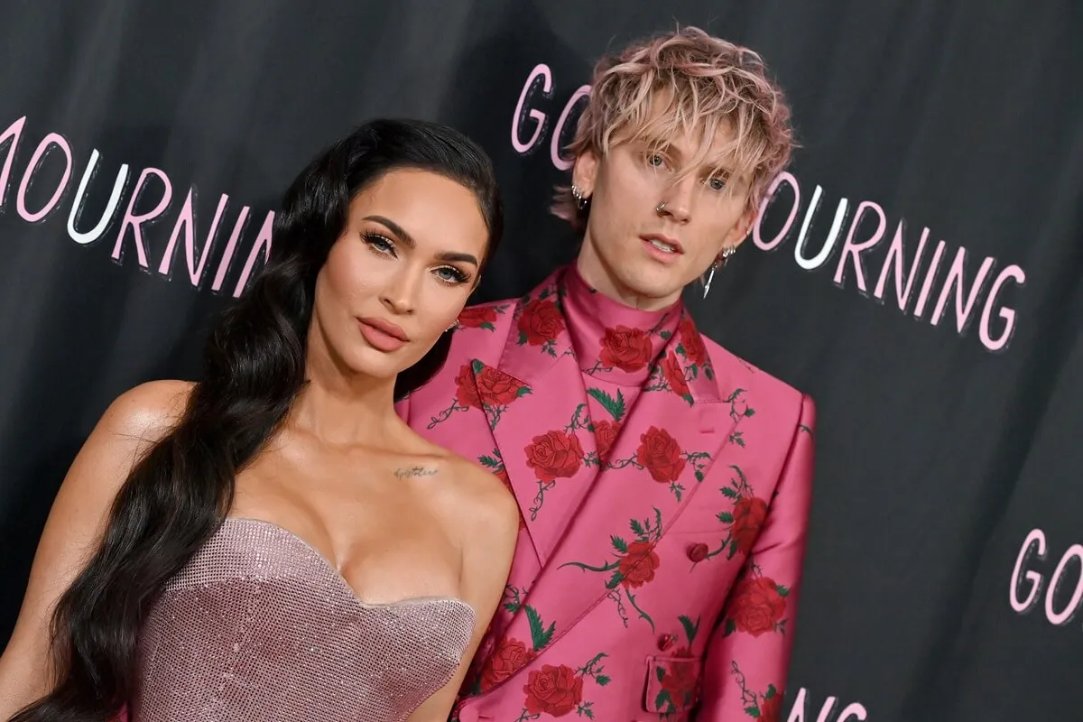 Megan Fox and Machine Gun Kelly posing in matching colored outfits at the World Premiere of "Good Mourning".