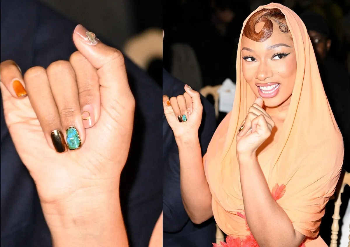 Wearing an orange gown, Megan Thee Stallion smiles for cameras at the Giambattista Valli Haute Couture Spring-Summer 2025 show