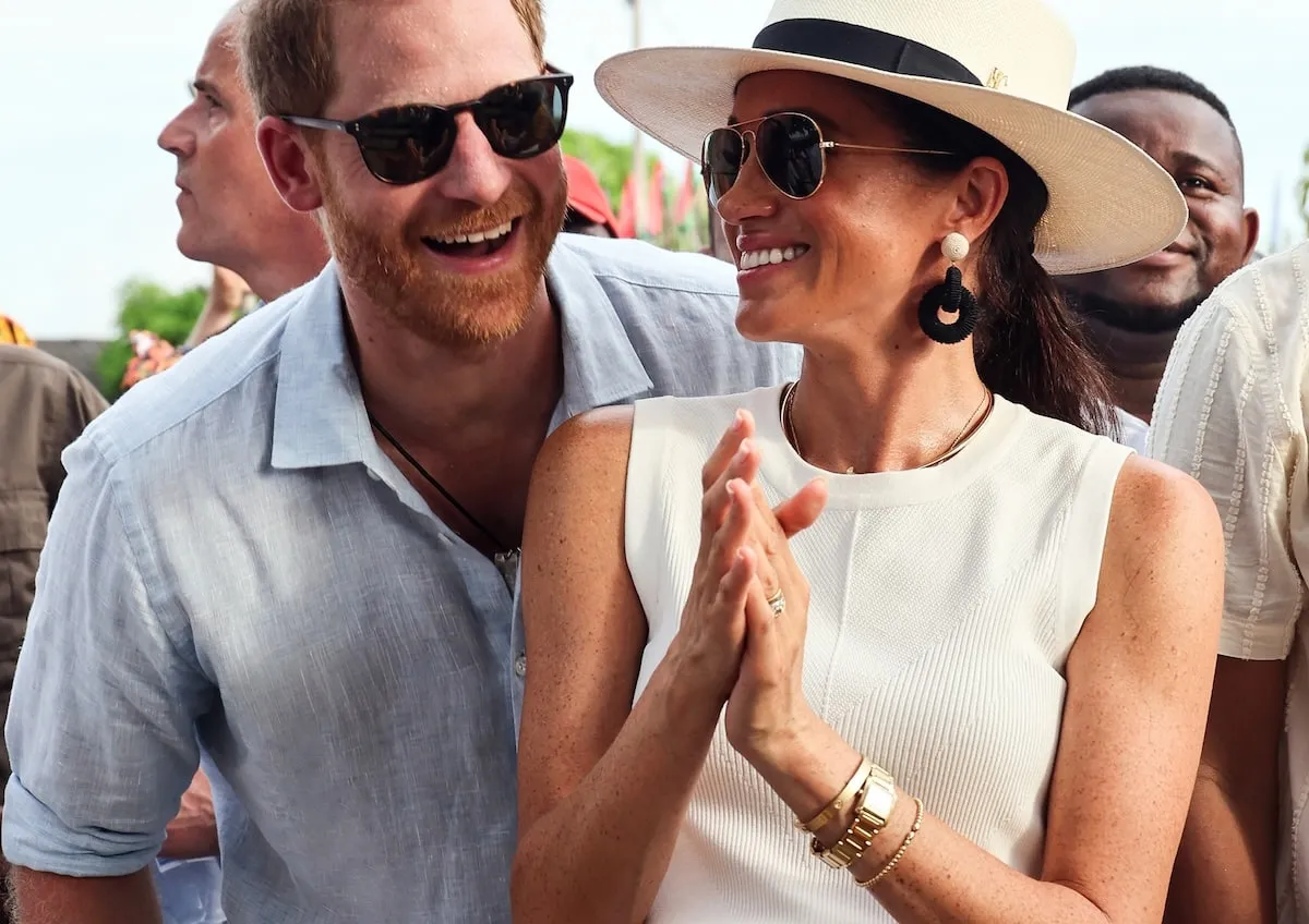 Smiling with Prince Harry, Meghan Markle attends an event in Columbia