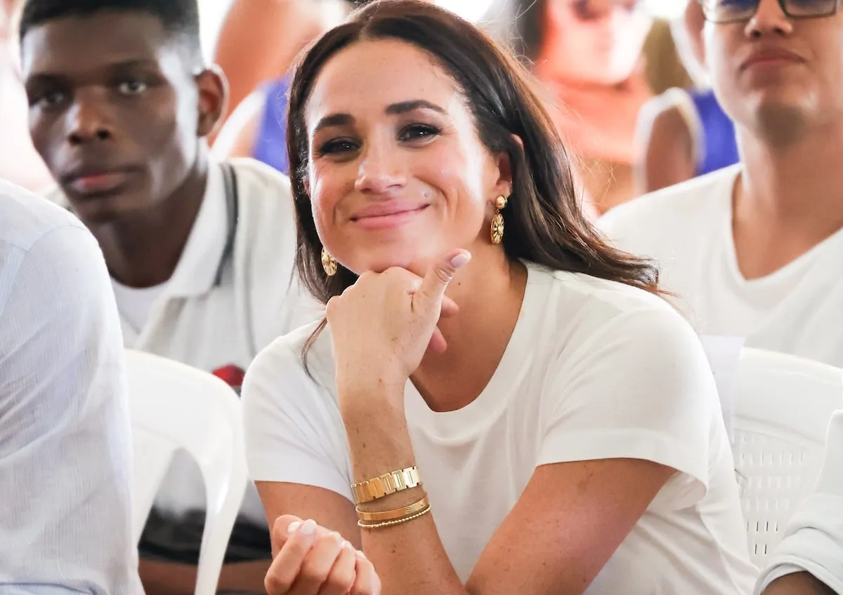 Wearing her Cartier love bracelet, Meghan Markle smiles during an event in Columbia