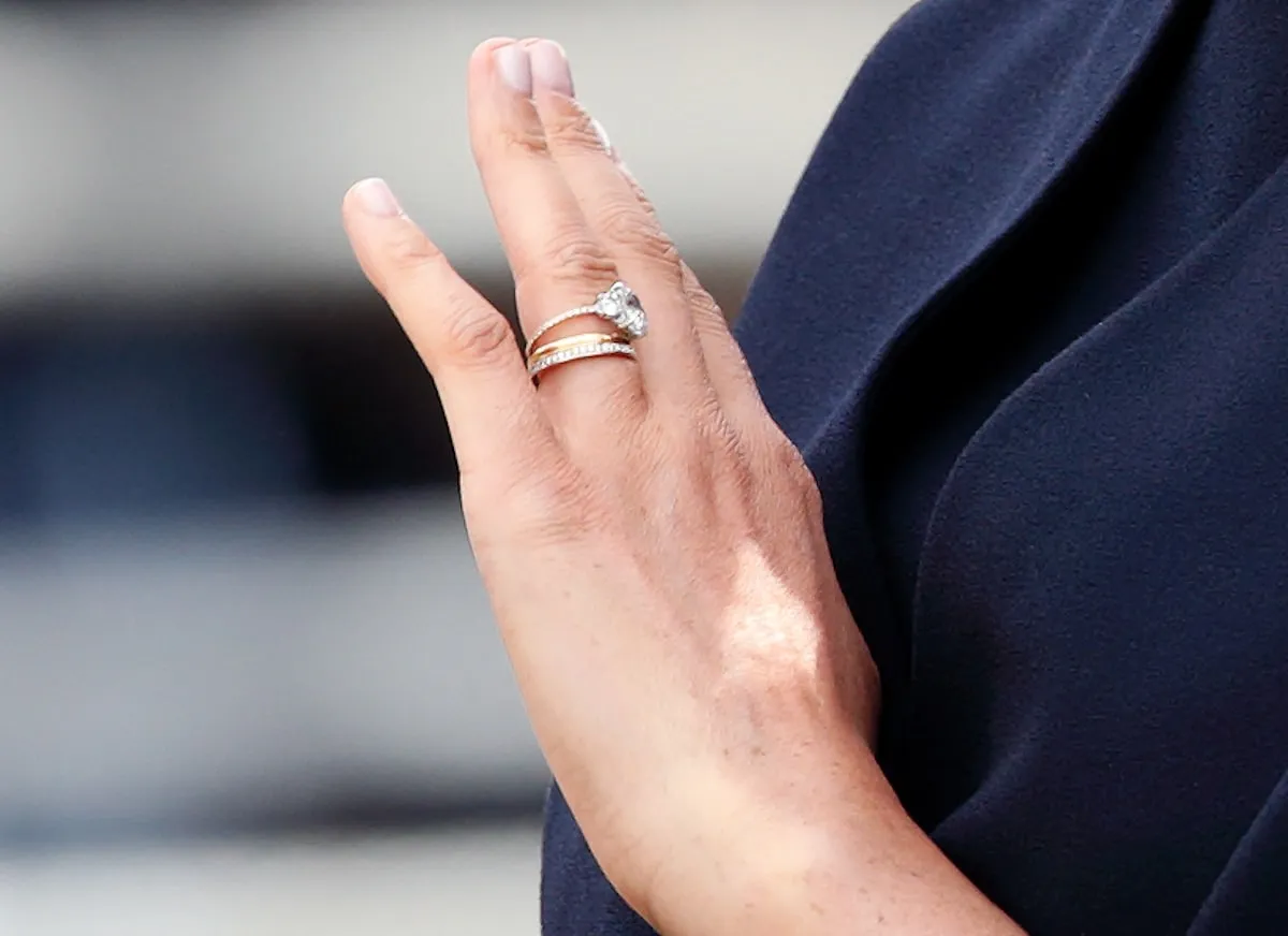 A closeup of Meghan Markle's engagement and wedding rings as she travels down The Mall in a horse drawn carriage during 2019 Trooping The Colour