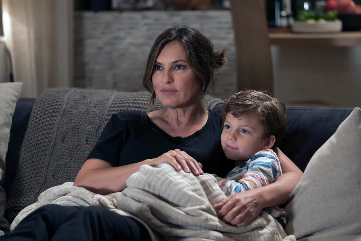 Mariska Hargitay as Olivia Benson sitting next to Ryan Buggley who's playing Noah Benson.