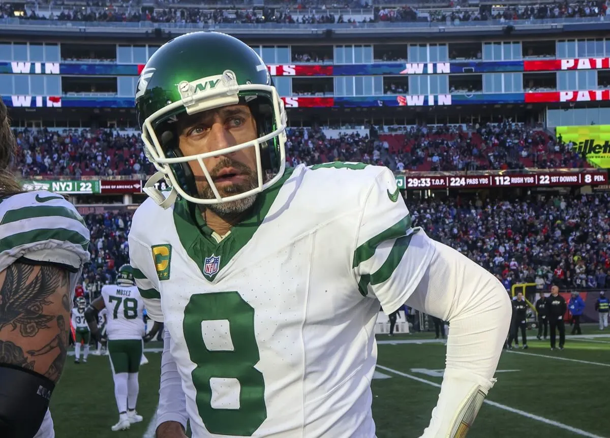 New York Jets quarterback Aaron Rogers walks of the field after the game