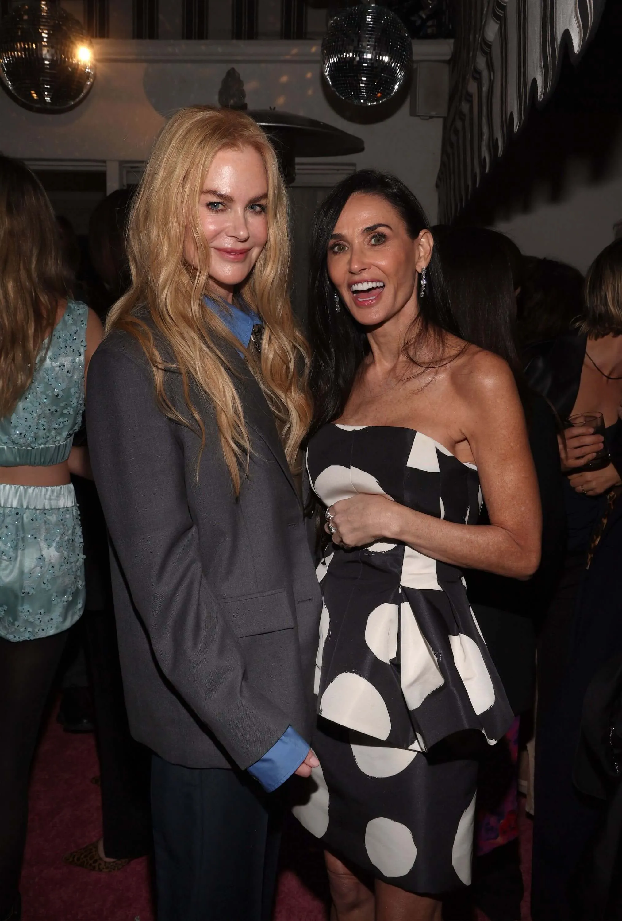 Nicole Kidman and Demi Moore standing next to each other and posing at an event in January 2024