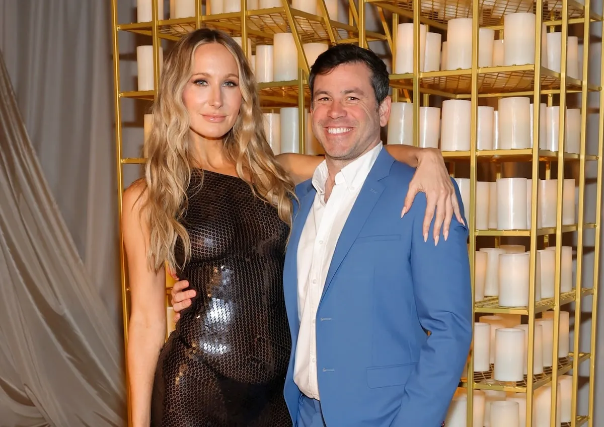 Wearing a sheer black dress, Nikki Glaser poses with her boyfriend, Chris Convy, in 2024