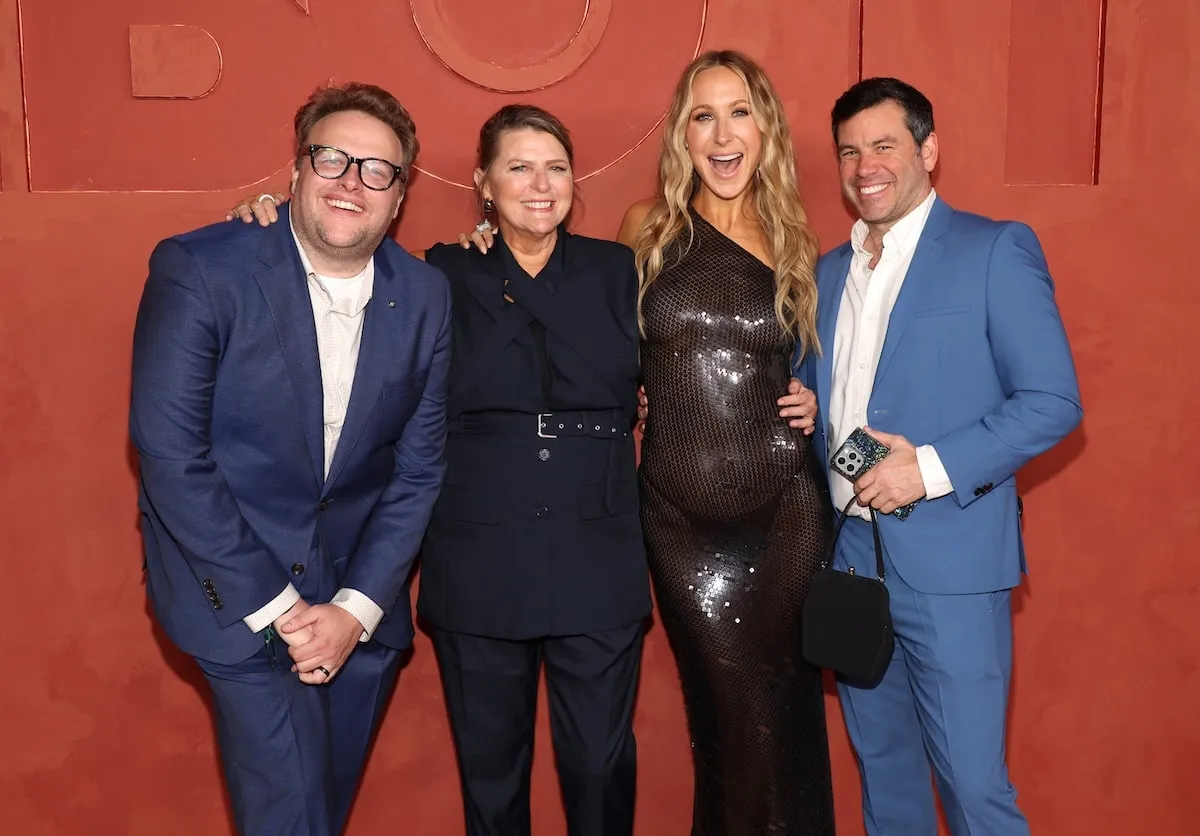 Wearing a black sheer dress, Nikki Glaser smiles with boyfriend Chris Convy, Sean O'Connor, and Julie Glaser