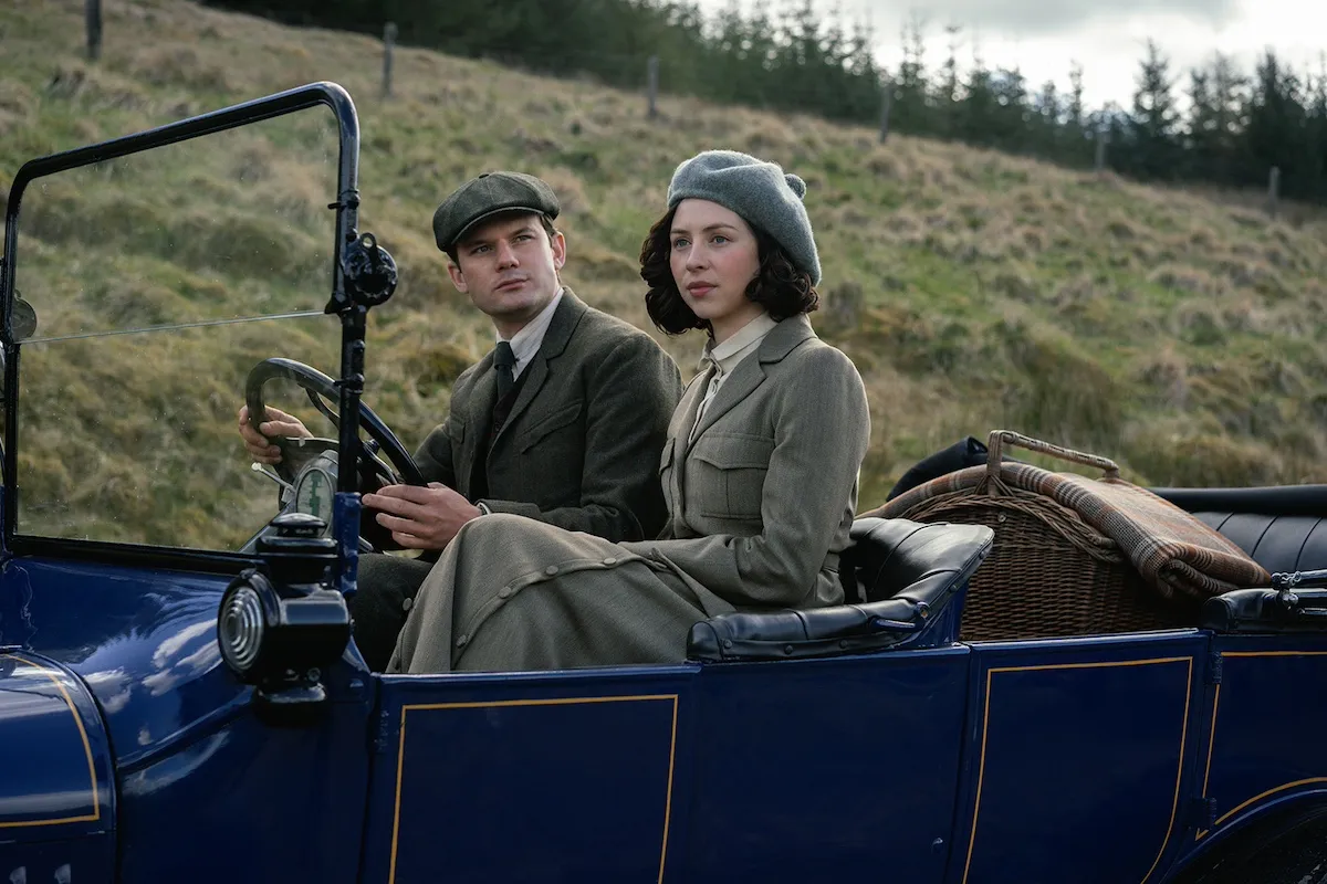 Young man and a woman in a car in early 20th century dress in the 'Outlander' prequrel series 'Blood of My Blood'