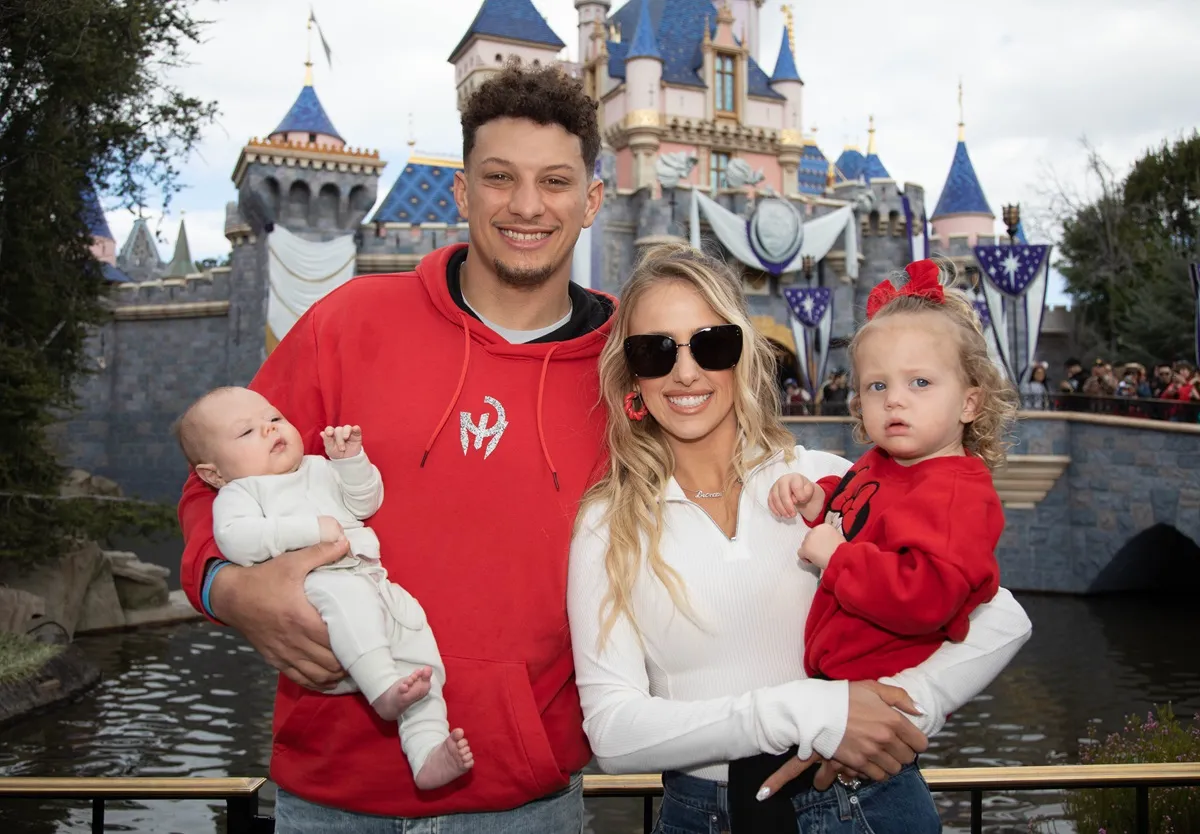 In this handout image provided by Disney, Patrick Mahomes of the Kansas City Chiefs and Brittney Mahomes pose with their children, Sterling, 1, and Bronze, 11 weeks old, in front of Sleeping Beauty Castle at Disneyland Park on February 13, 2023,