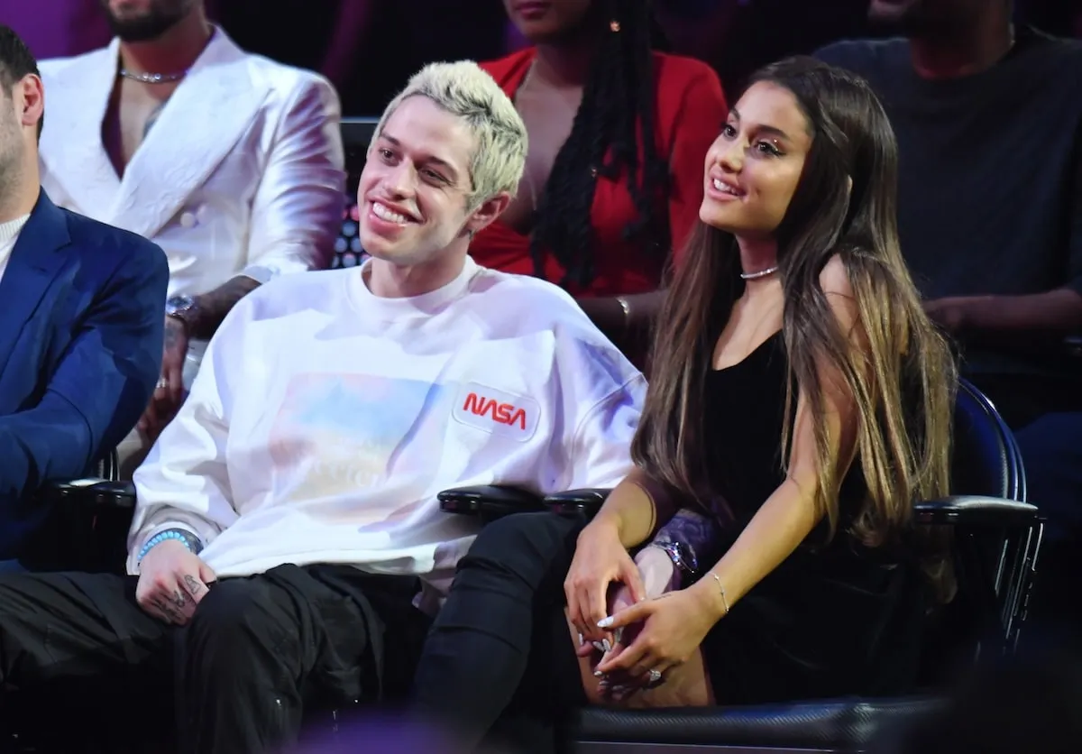 Holding hands front row, Pete Davidson and Ariana Grande watch the 2018 MTV Video Music Awards