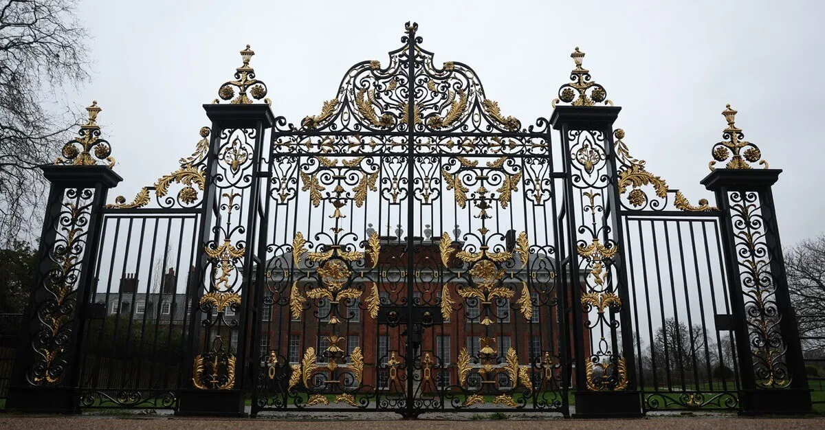 Photo of Kensington Palace in London seen beyond gate