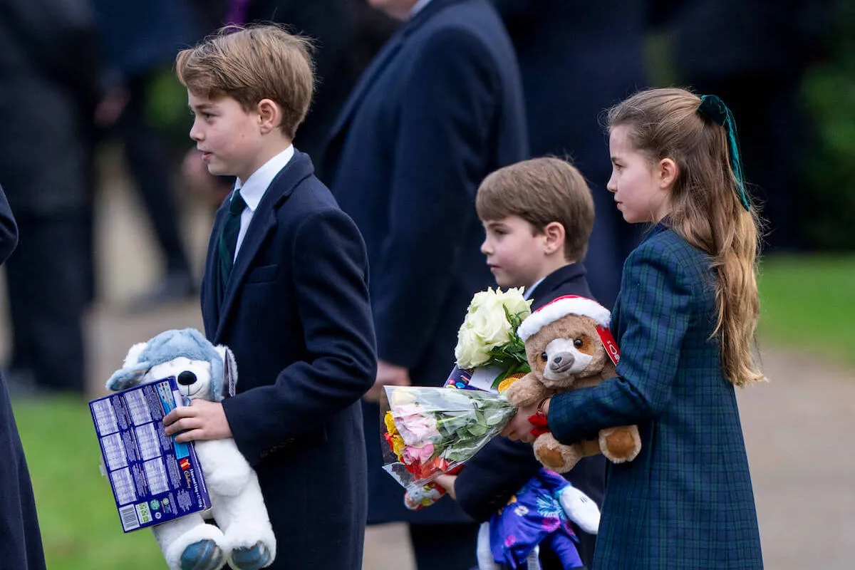 Prince George, Prince Louis, and Princess Charlotte on Christmas Day carrying gifts