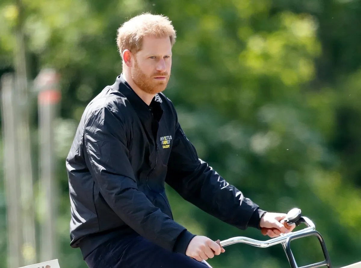 Prince Harry rides a bicycle around Sportcampus Zuiderpark as part of a program of events to mark the official launch of the Invictus Games