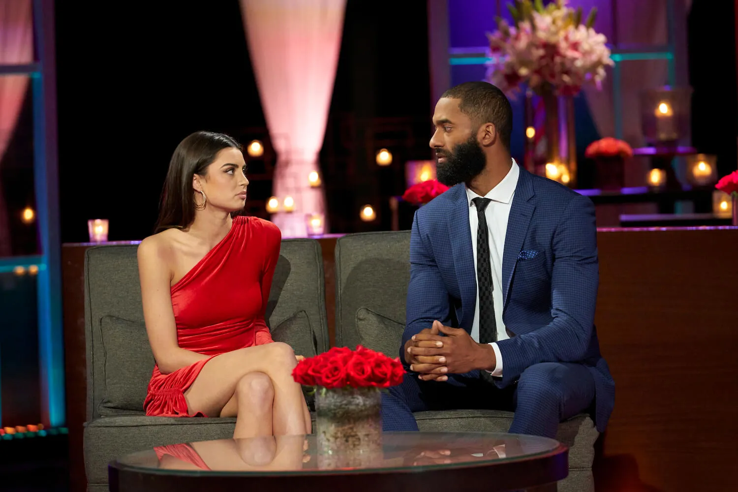 Rachael Kirkconnell and Matt James sitting next to each other on 'The Bachelor' Season 25 After the Final Rose. Rachael is wearing a red dress and Matt is wearing a suit.