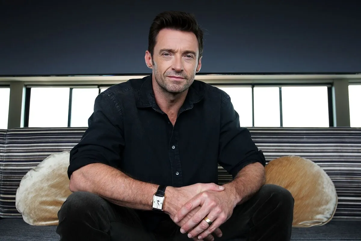 Hugh Jackman poses during a photo call to promote his new film Real Steel in a black outfit.