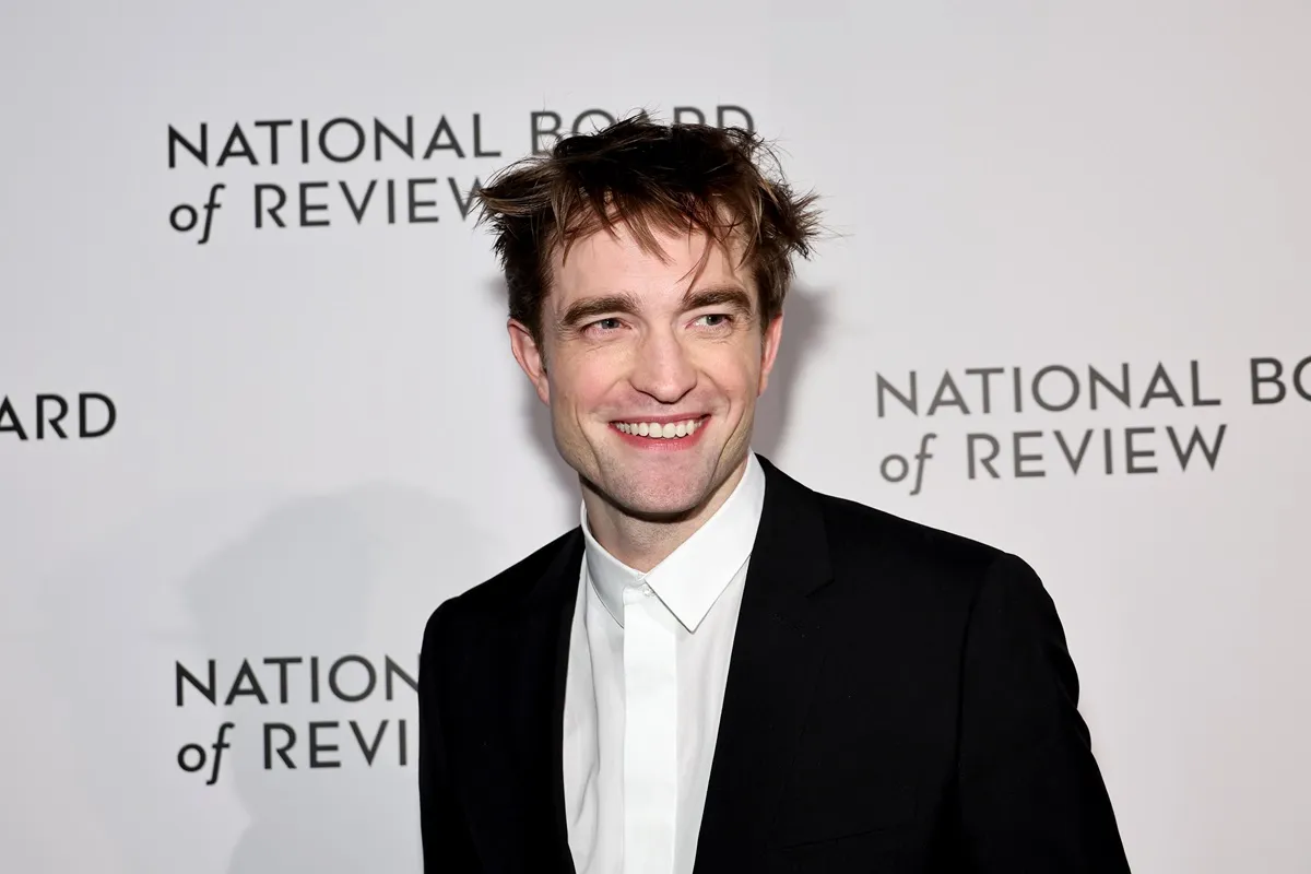 Robin Pattinson posing in a suit at The National Board of Review Annual Awards Gala at Cipriani 42nd Street.