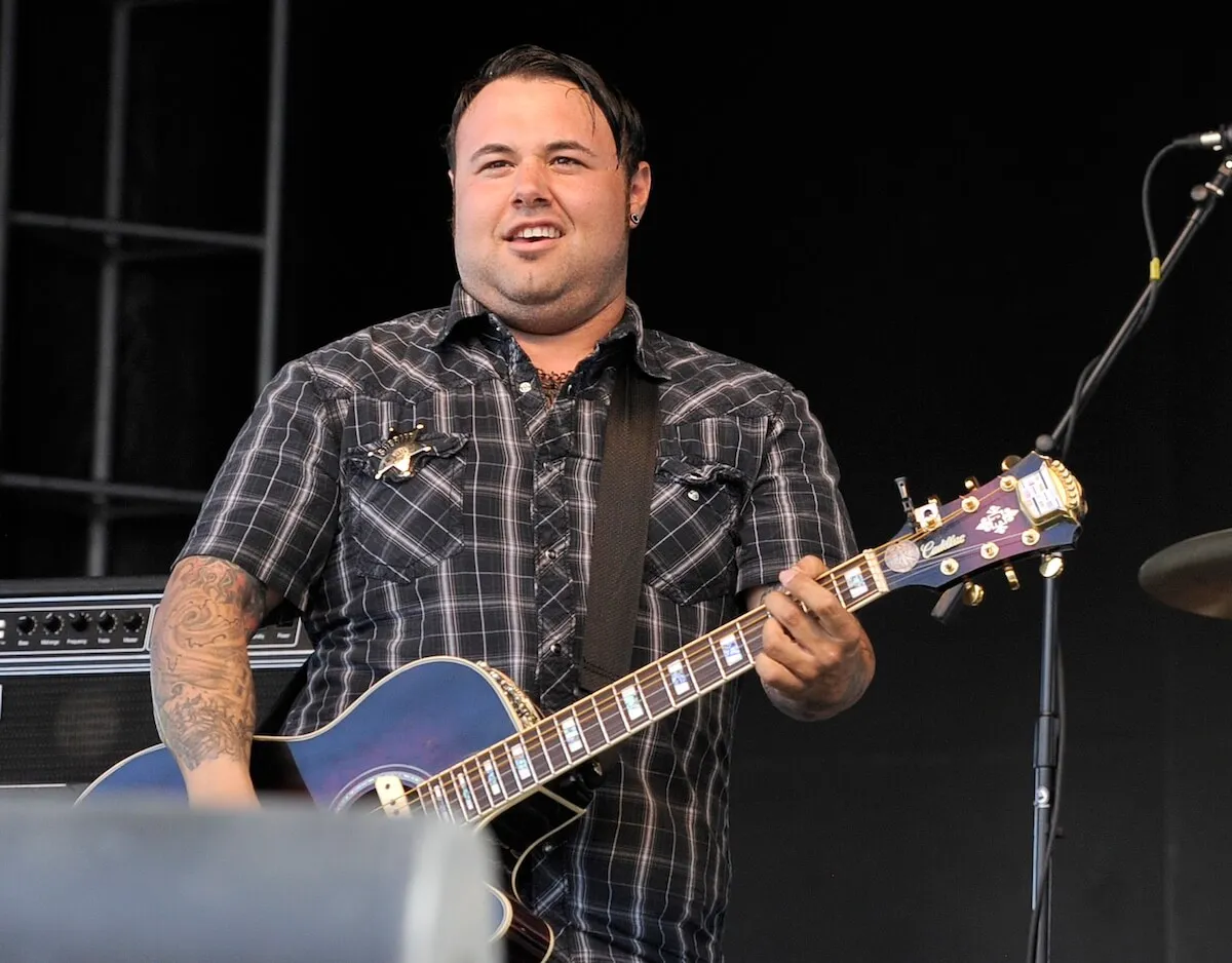 Ryan Whyte Maloney with a guitar