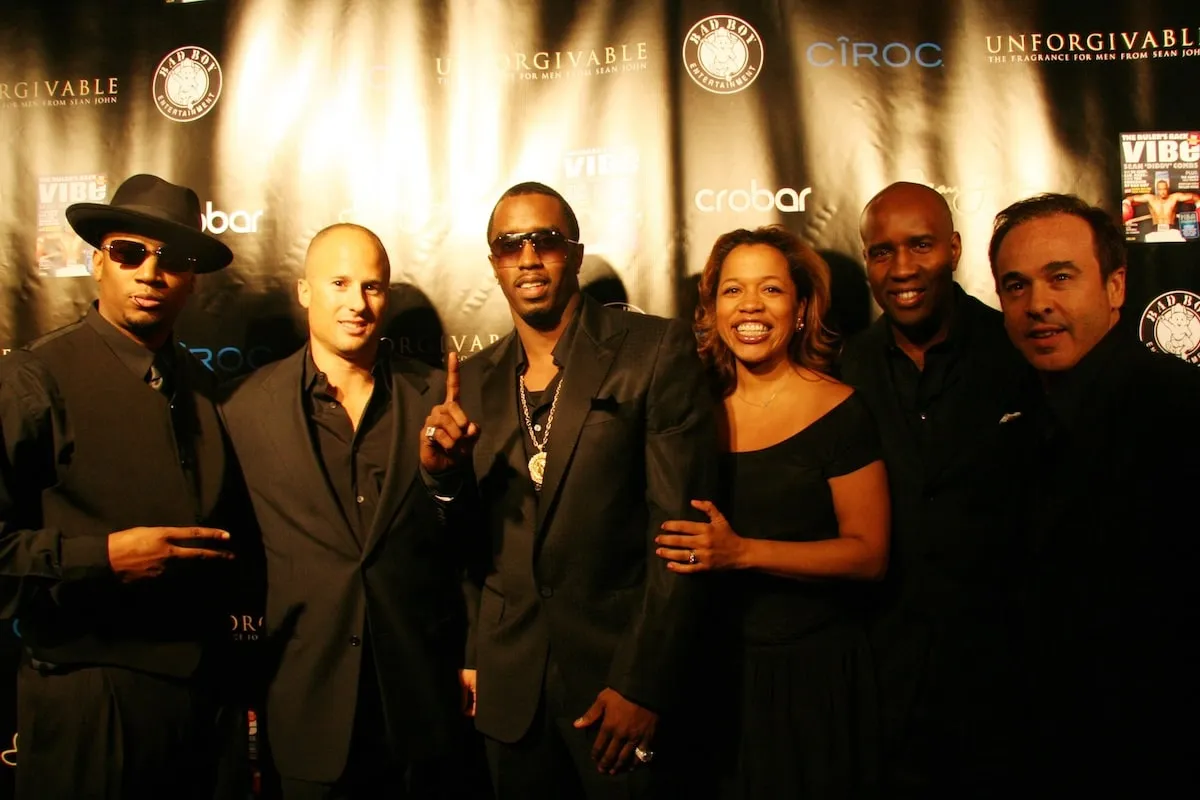 Diddy stands with the VIBE magazine team during his cover shoot celebration party