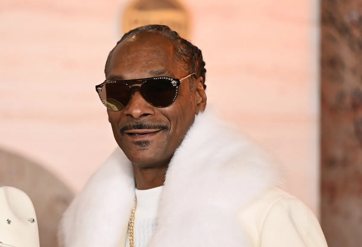 Snoop Dogg wearing white fur and sunglasses