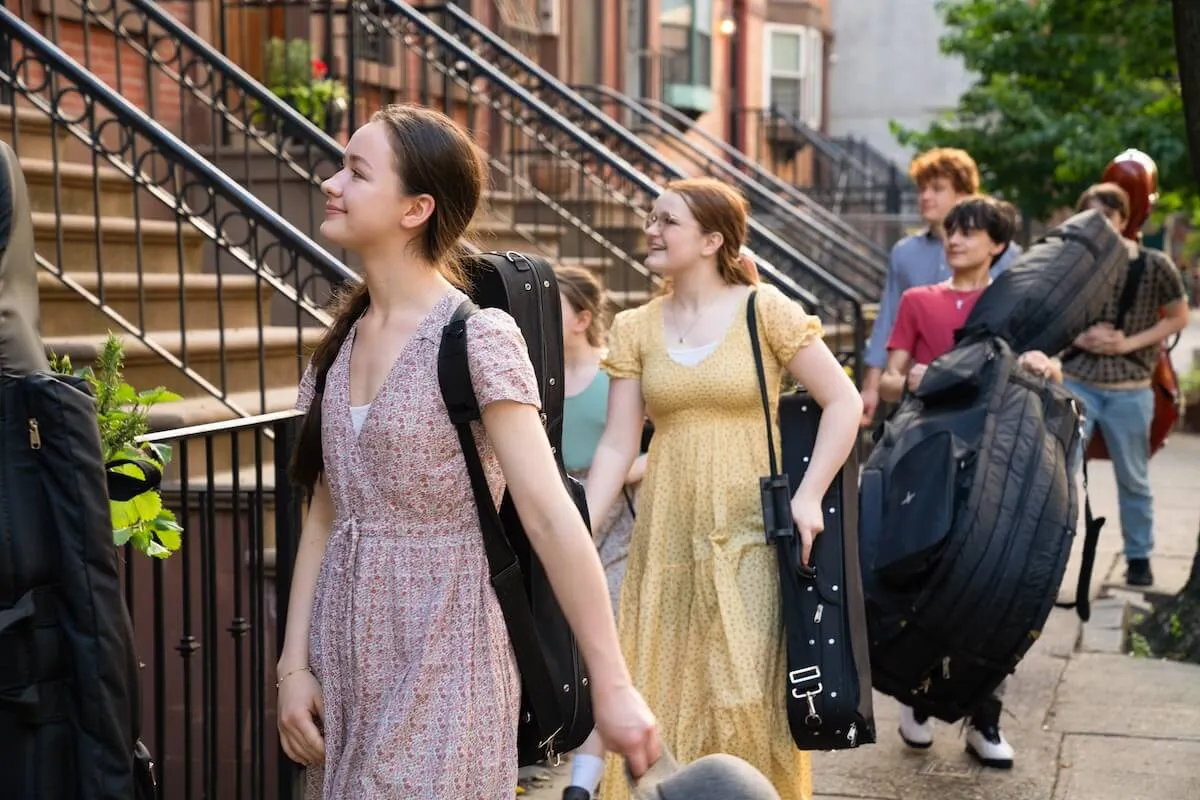 Smiling children from the de la Motte family carrying instruments on an NYC street in 'Big City, Big Family' on TLC