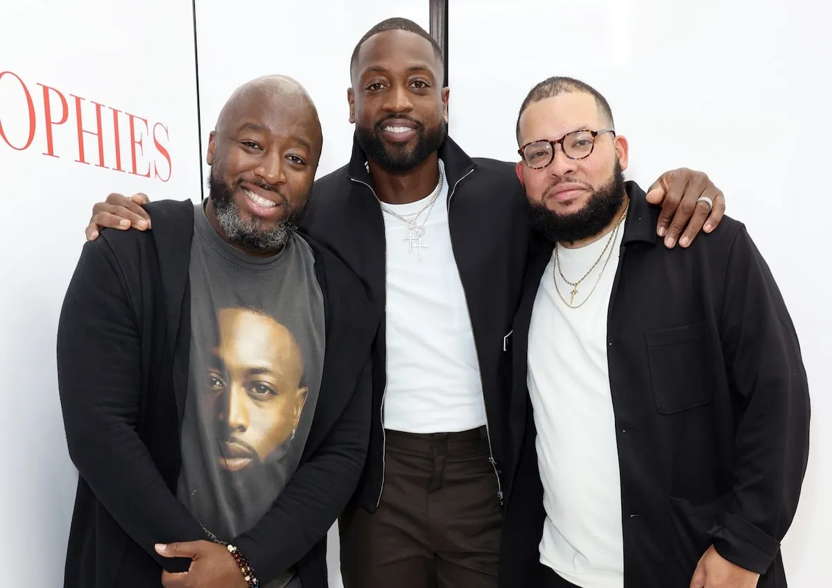 Dwyane Wade smiles with Bob Metelus and Justin Tinsley at a 2021 event in Miami