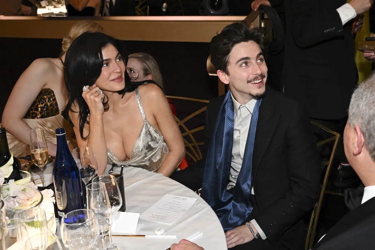 Sitting together at their table,Kylie Jenner and Timothée Chalamet chat with guests