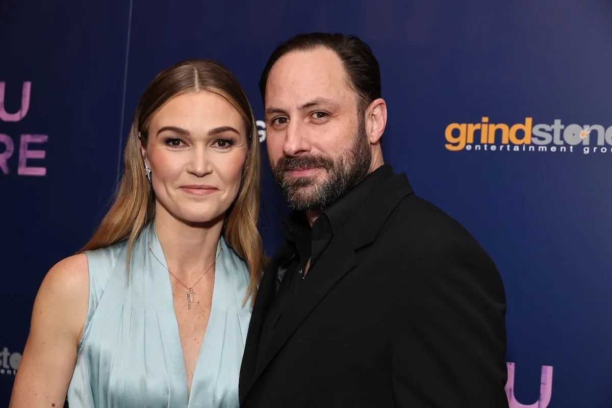 Married couple Julia Stiles and Preston Cook smile together on the red carpet at a screening of her directorial debut of film 'Wish You Were Here'