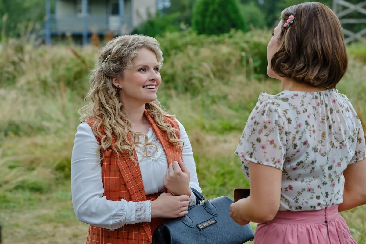 Andrea Brooks as Faith Carter, holding a doctor's bag and talking to Elizabeth (Erin Krakow) in 'When Calls the Heart' Season 12