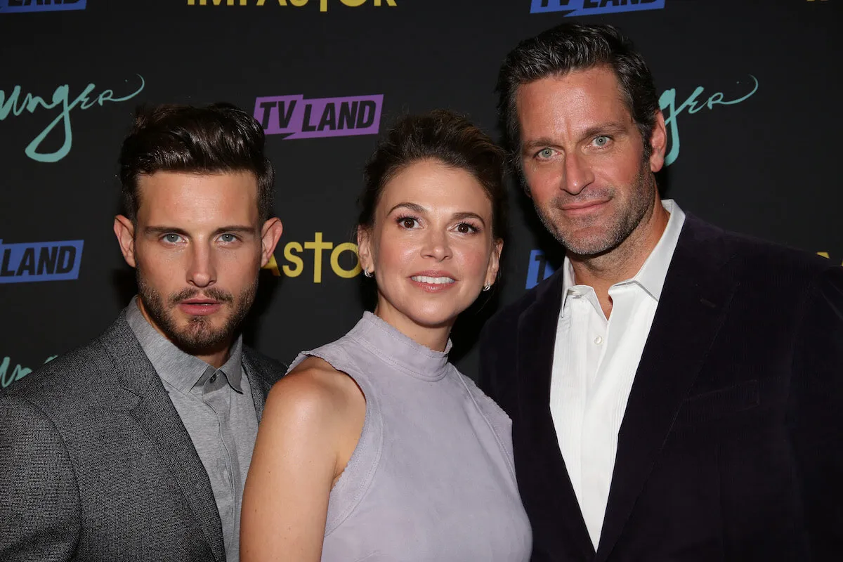 'Younger' stars Nico Tortorella, Sutton Foster, and Peter Hermann pose together on the red carpet.