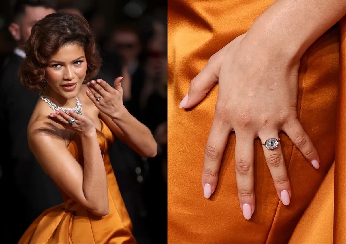 Wearing an orange dress, Zendaya poses on the red carpet in an orange Louis Vuitton dress while wearing her engagement ring from Tom Holland