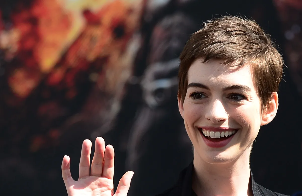 Anne Hathaway posing at Christopher Nolan's Hand and Foot print ceremony in front of Grauman's Chinese Theater in Hollywood.