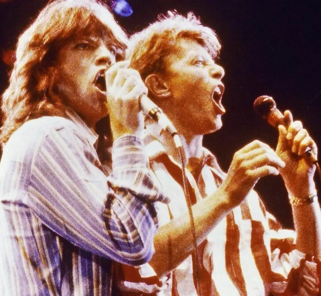 Mick Jagger of The Rolling Stones and David Bowie with microphones