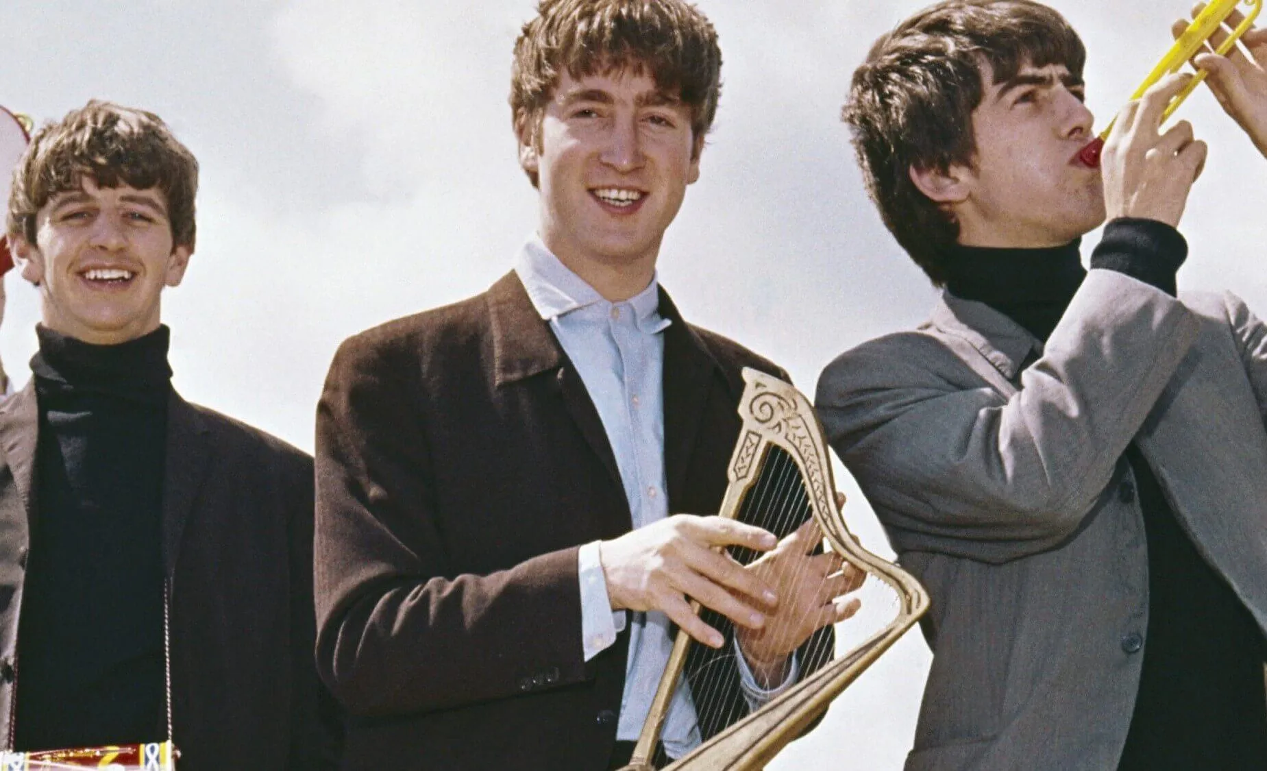 Members of The Beatles with instruments