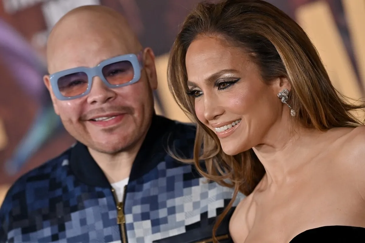 Jennifer Lopez posing alongside Fat Joe at the premiere of 'This Is Me...Now'.