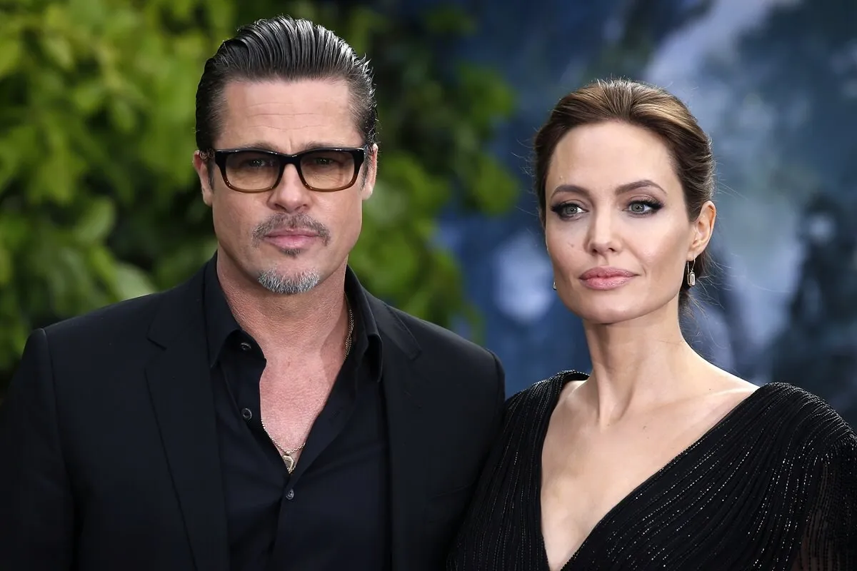 Brad Pitt and Angelina Jolie posing in matching-colored outfits at the 'Maleficent' premiere.