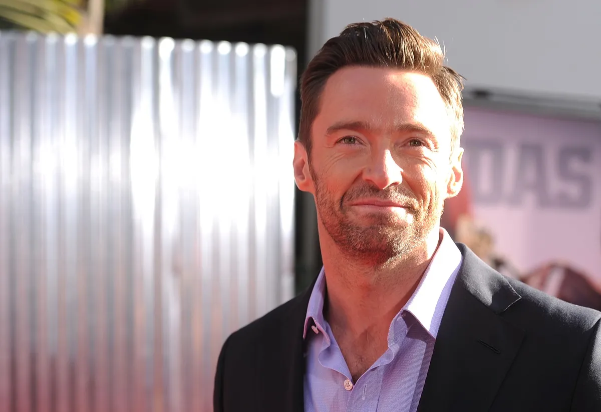 Hugh Jackman posing at the LA premiere of 'Real Steel' in a purple suit.