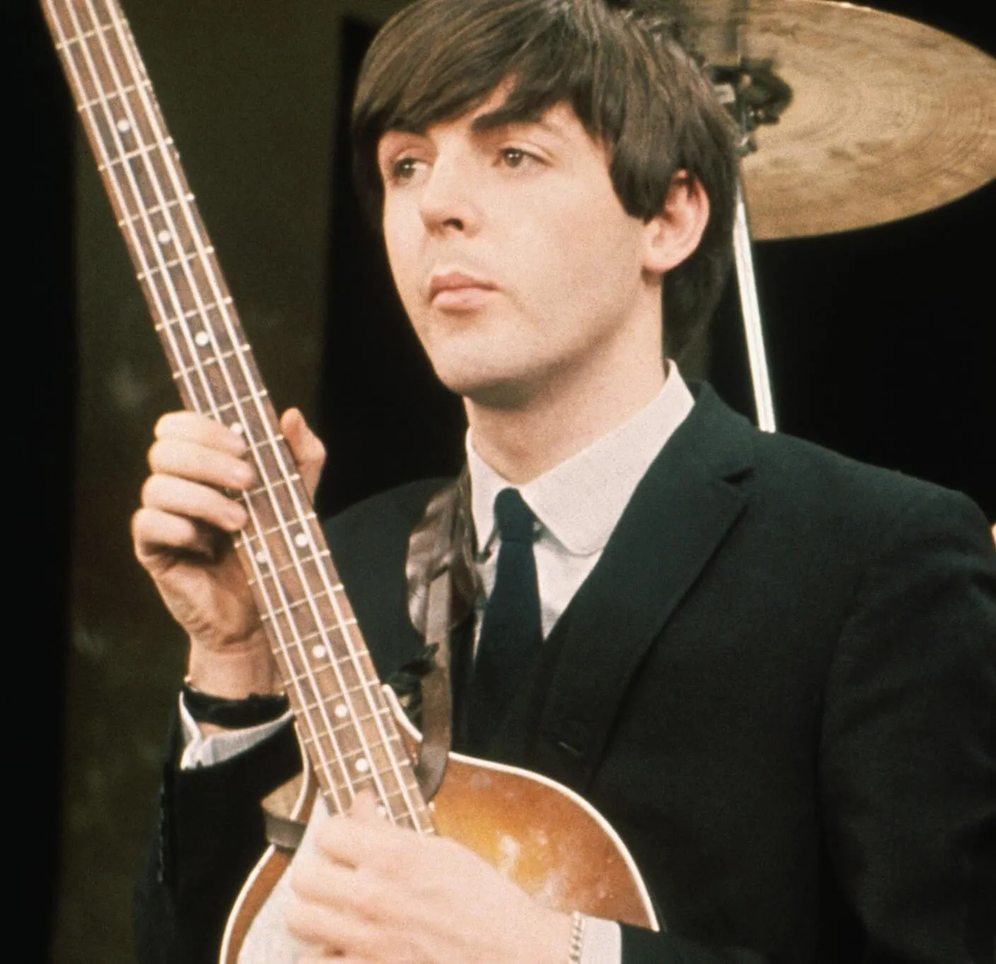 Rock star Paul McCartney playing songs with a guitar