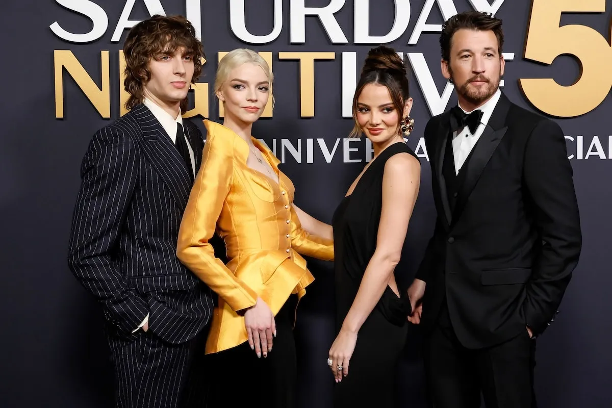 Wearing formalwear, Malcolm McRae, Anya Taylor-Joy, Keleigh Sperry Teller, and Miles Teller pose together on the red carpet before 'SNL50'