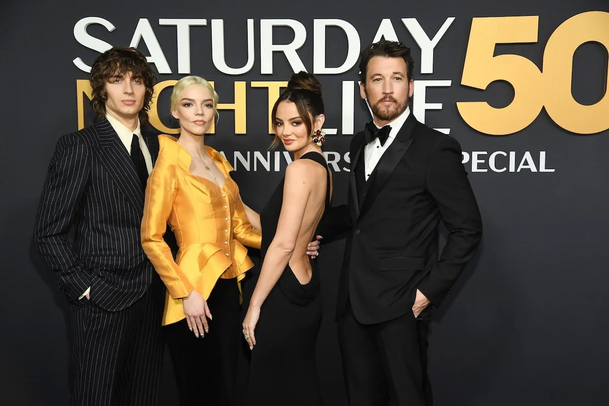 Wearing formalwear, Malcolm McRae, Anya Taylor-Joy, Keleigh Sperry Teller, and Miles Teller pose together on the red carpet before 'SNL50'