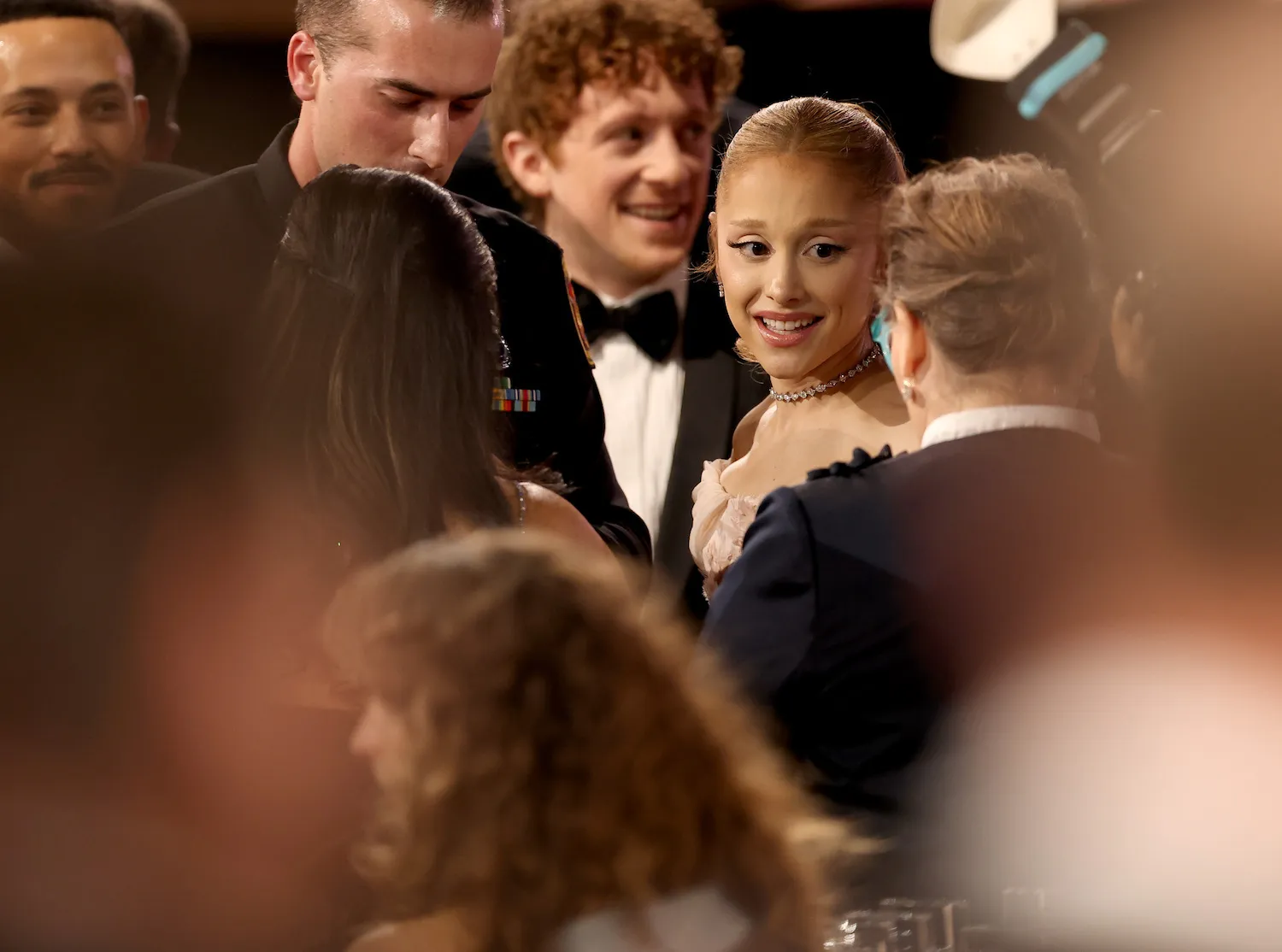 Ethan Slater and Ariana Grande smiling amidst a crowd at the SAG Awards