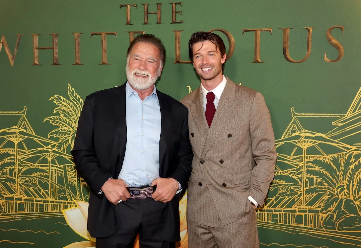 Father and son Arnold Schwarzenegger and Patrick Schwarzenegger stand together on the red carpet at The White Lotus season 3 premiere