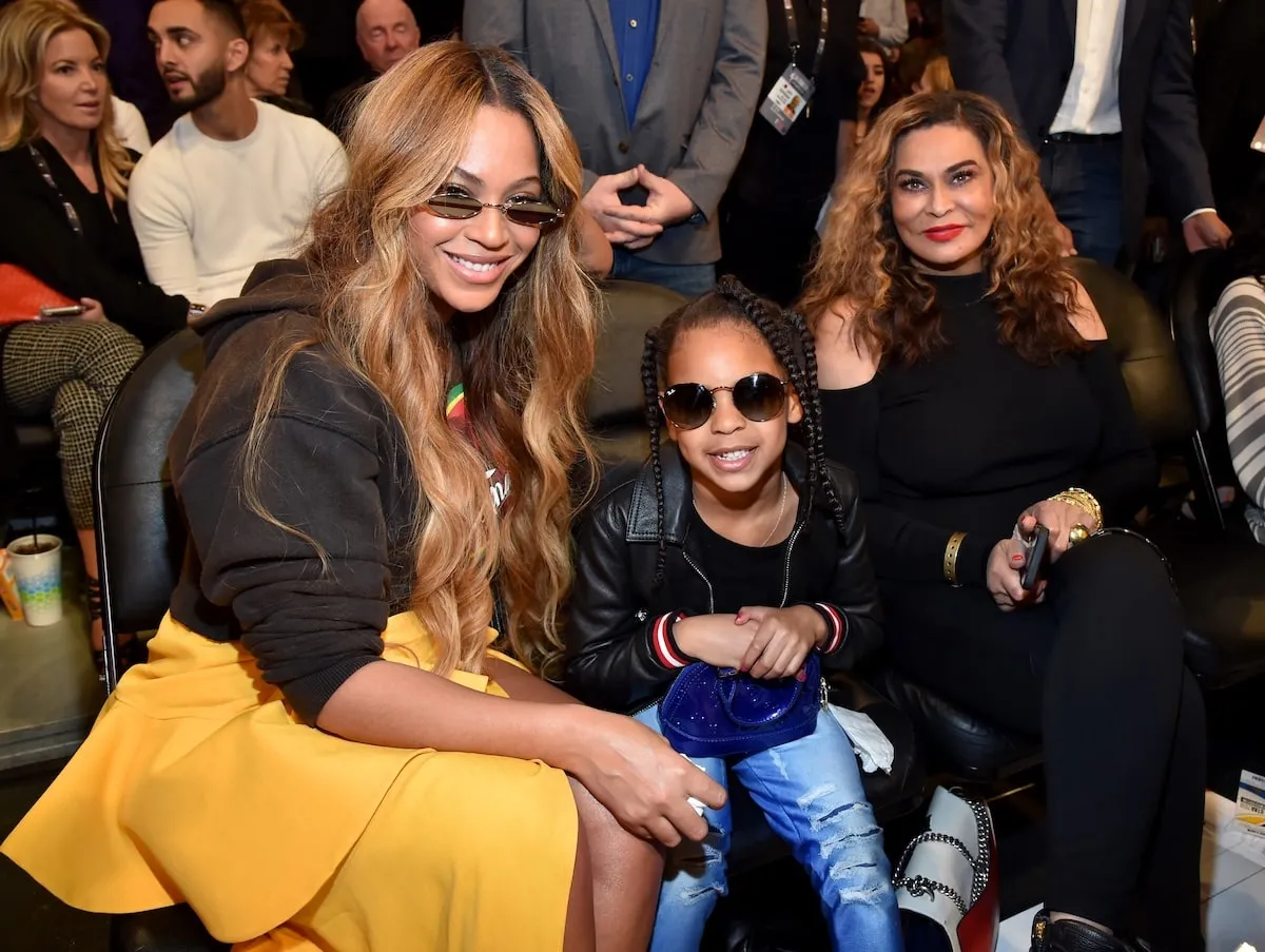 Sitting courtside, Beyonce, Blue Ivy Carter, and Tina Knowles smile at the 2018 NBA All-Star Game