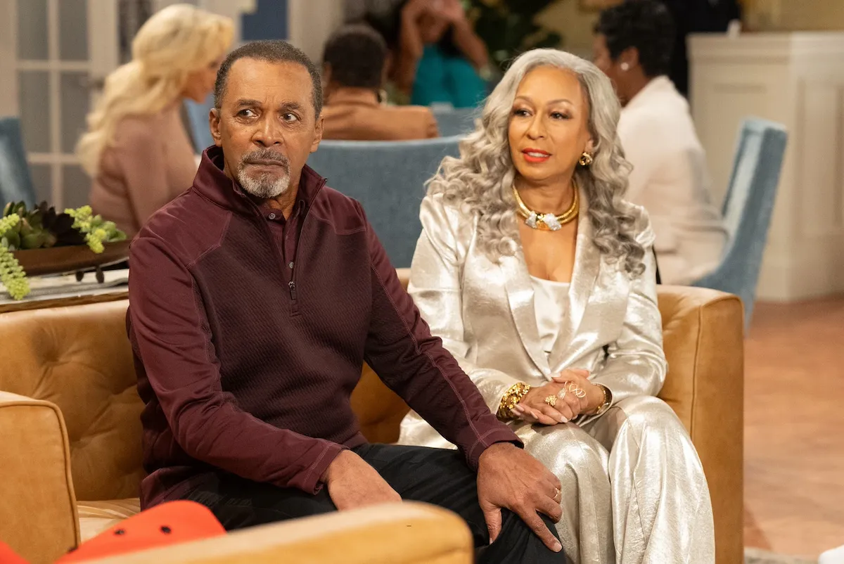 An older black man and black woman sitting on a couch in 'Beyond the Gates'