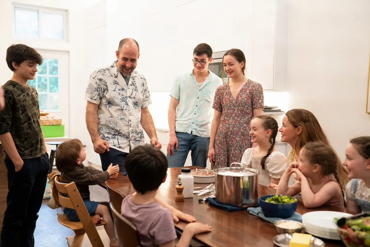 Large family sitting around a table in TLC's 'Big Family, Big City'