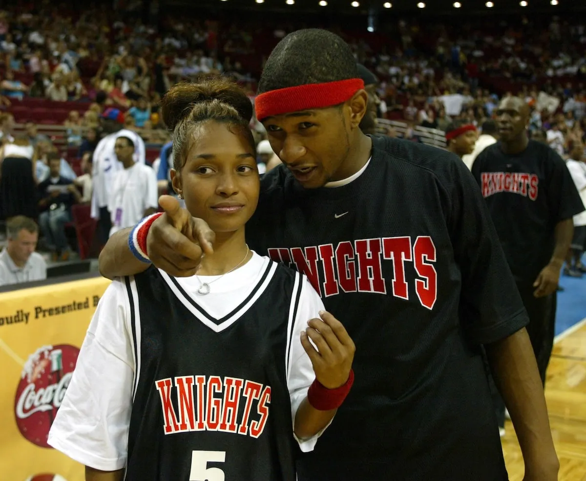 Usher and Chilli stand on the sideline of a 2002 celebrity basketball hosted by NSYnC