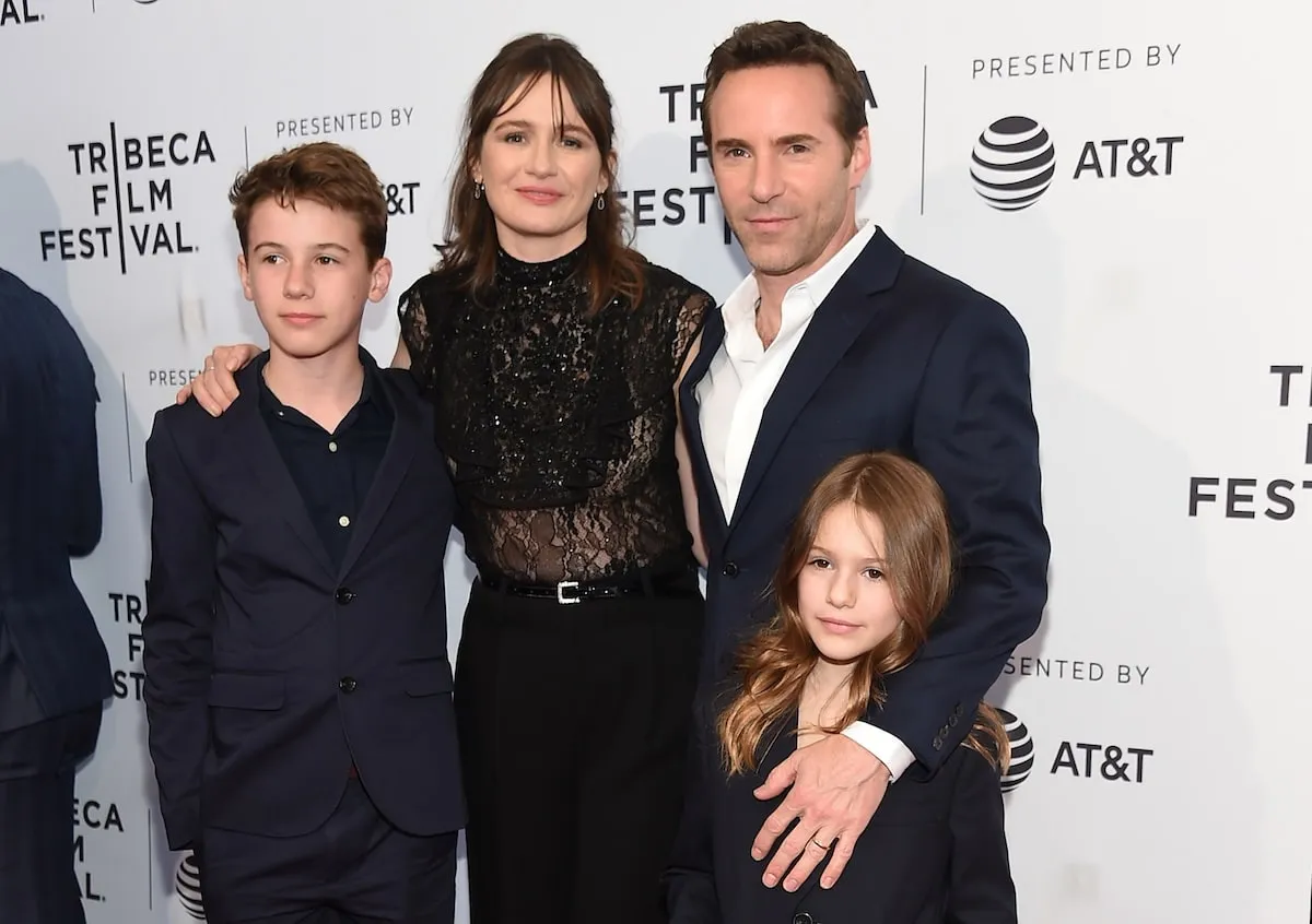 Wearing a black suit, 15-year-old Sam Nivola poses with his parents and sister on the red carpet at the 2018 Tribeca Film Festival in New York City