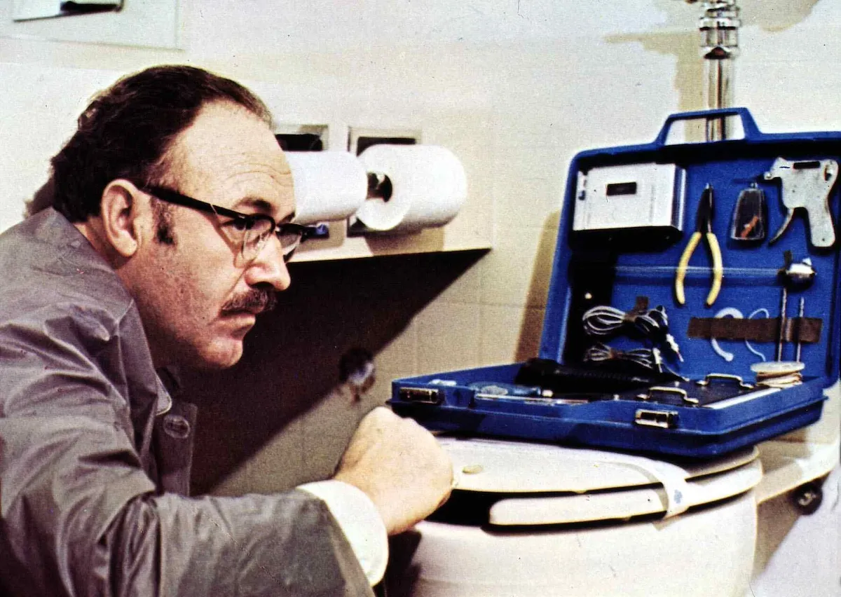 Gene Hackman, wearing glasses and using a listening device in 'The Conversation'